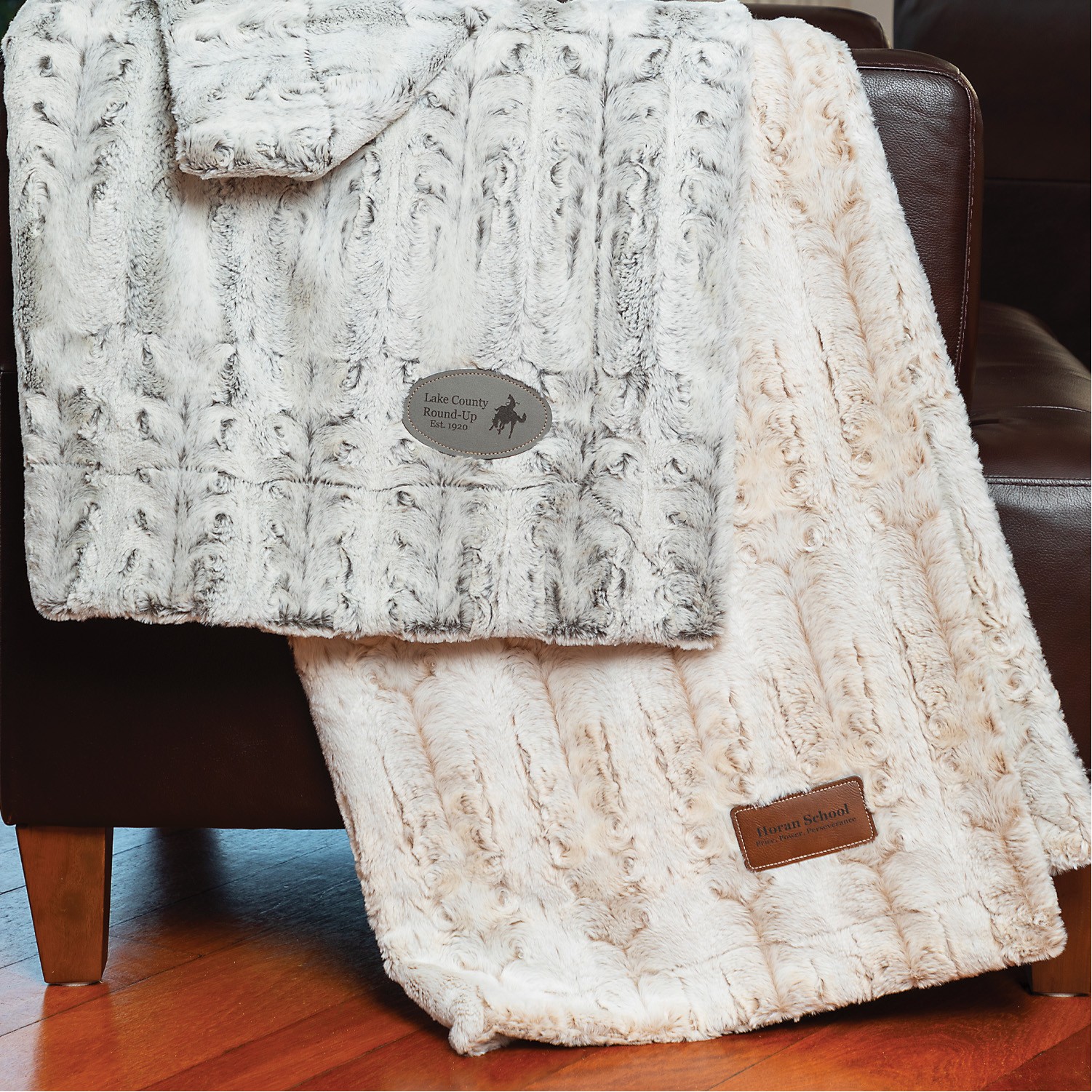 Custom embroidered or printed blankets for corporate holiday gifts or school booster club merch